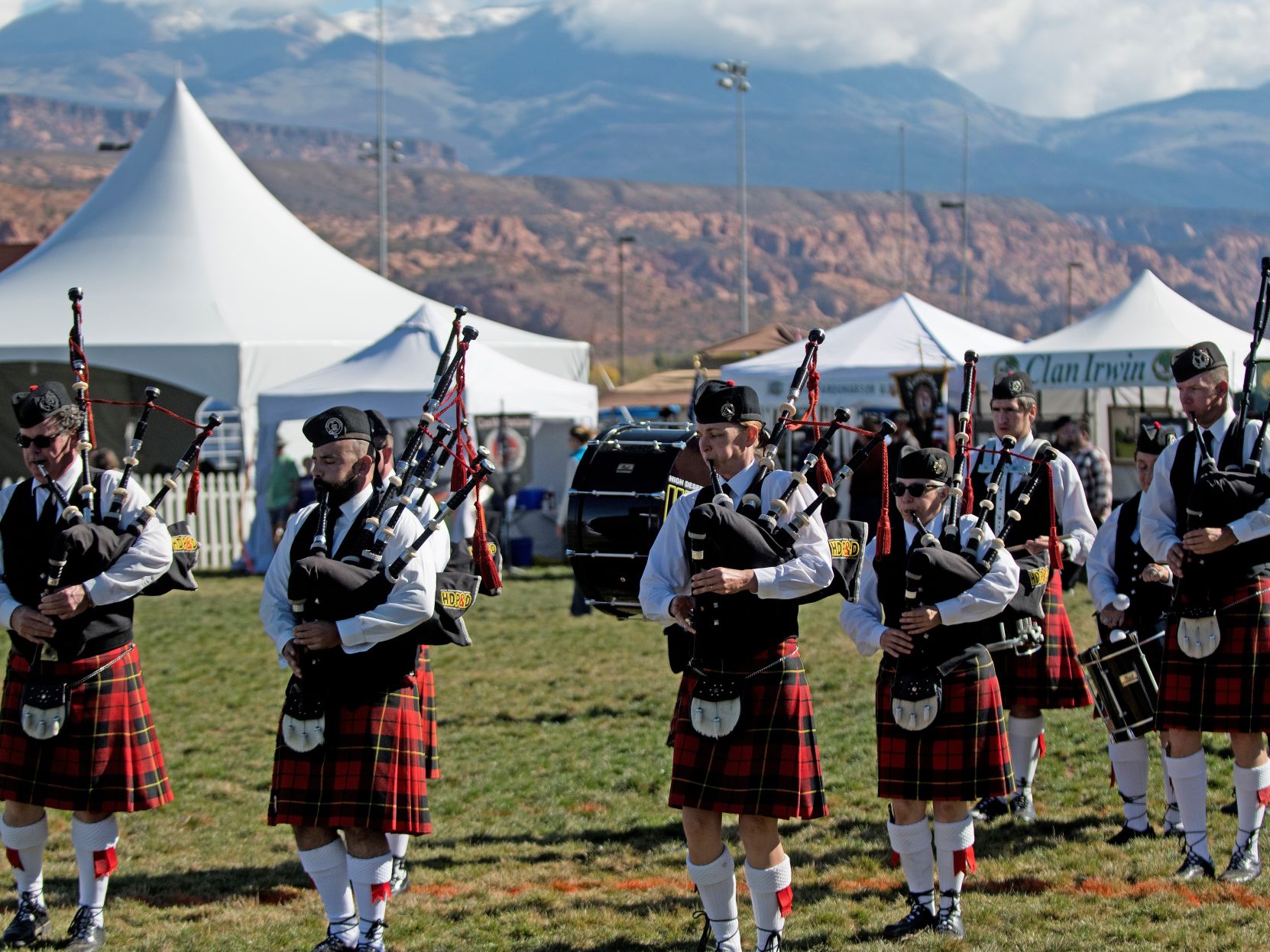 Musicians in traditional costume play bagpipes at a prior Scots on the Rocks Festival; they are playing at the Old Spanish Trail Arena.