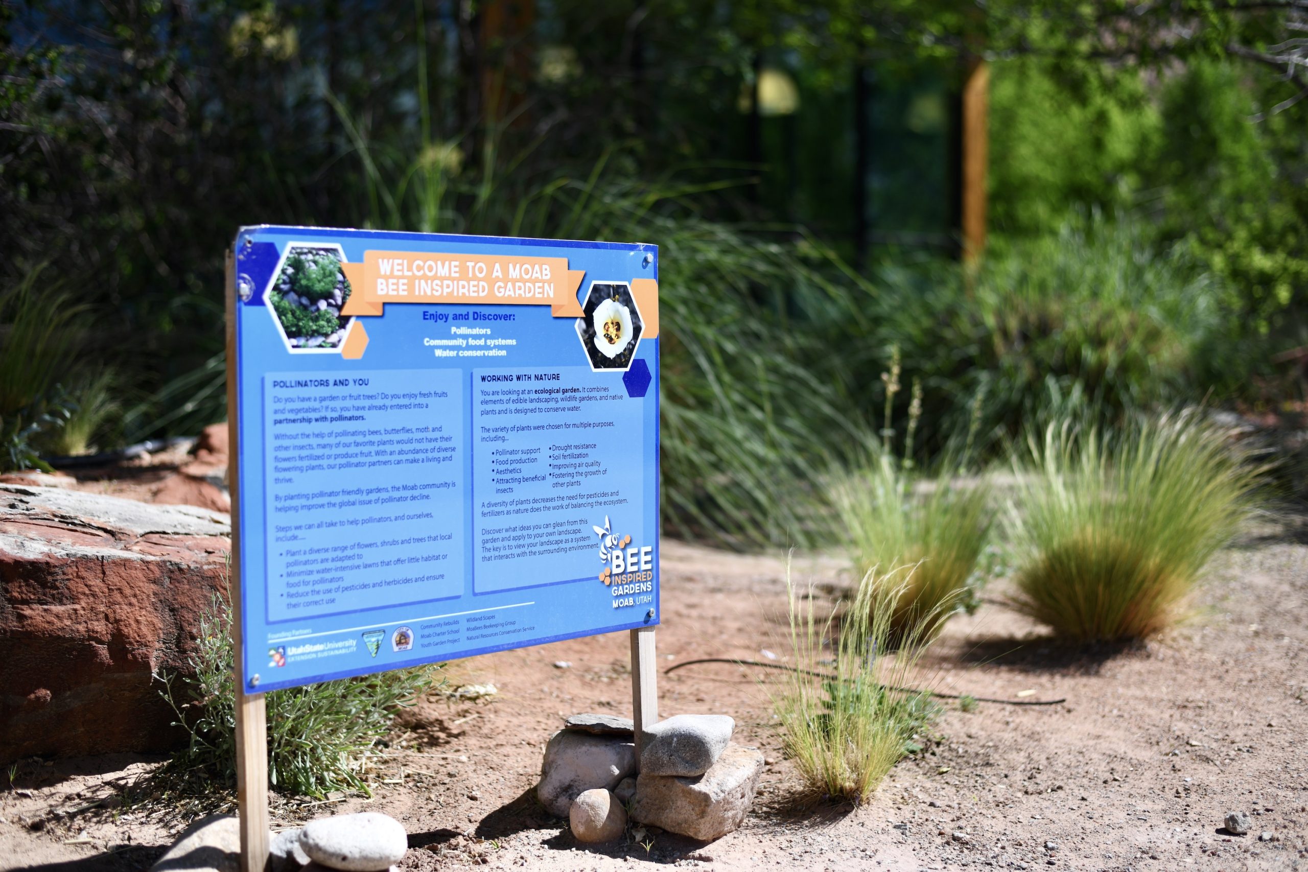 A sign in the library yard that says "Welcome to a Moab Bee Inspired Garden"