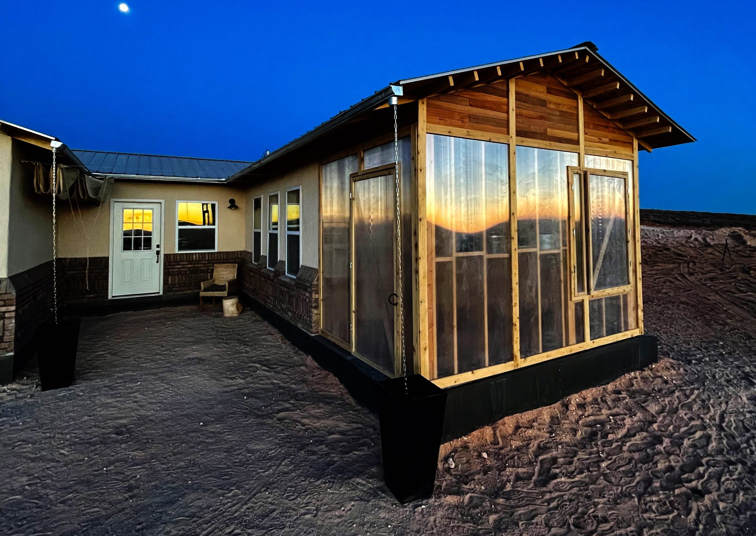 The "horseshoe" house is a house shaped literally like a horseshoe; in this photo, one side of the house is visible. It's mid-construction.