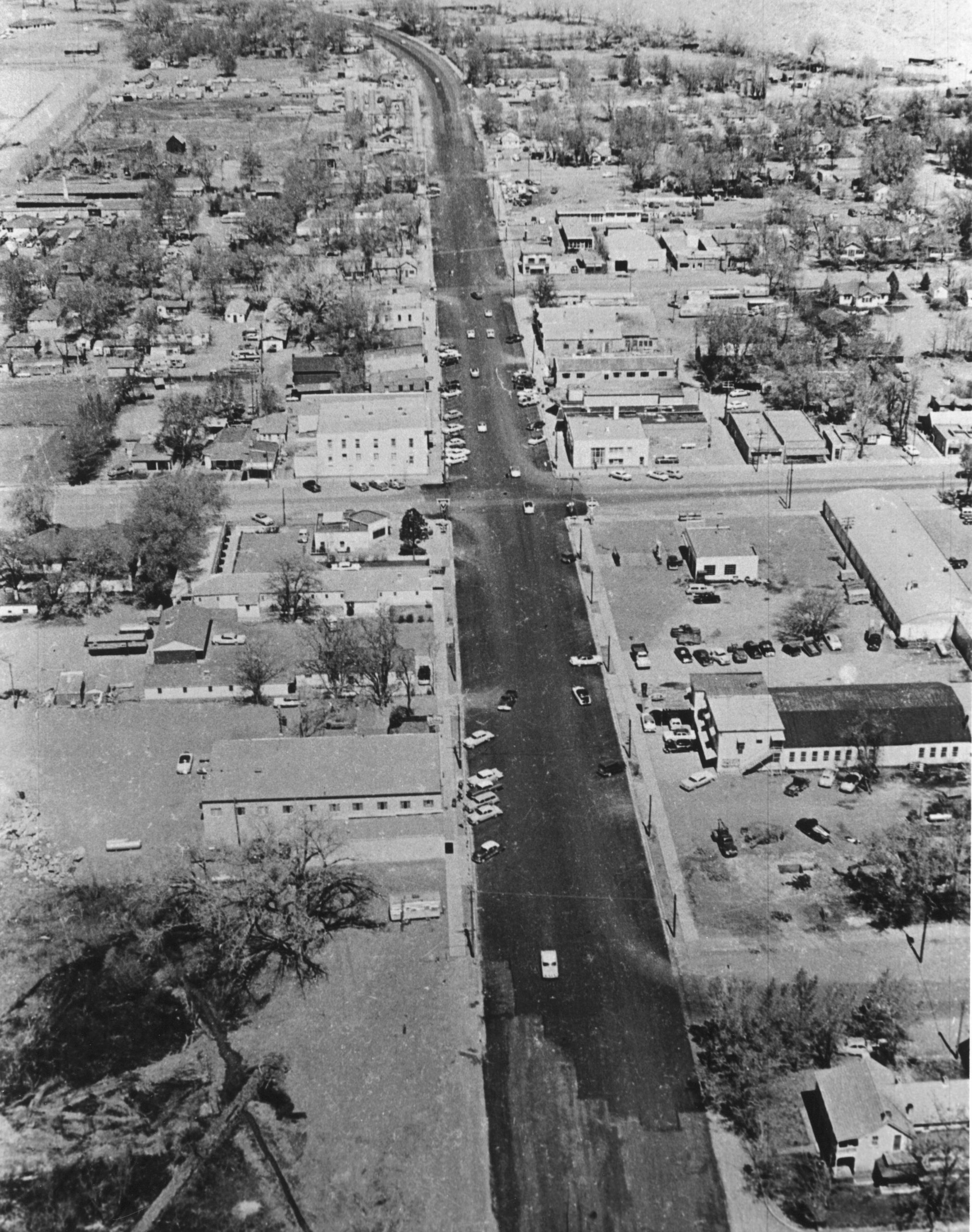 A black and white photo showing the aerial view of downtown Moab: compared to today, downtown in the 60s was much more sparse, though still impressive.