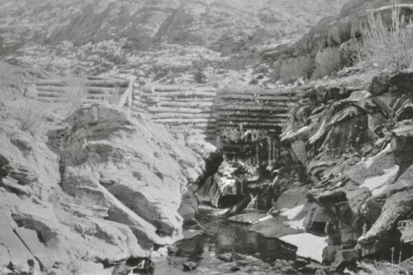 A grainy, black and white photo of a log dam at the mouth of Mill Creek.