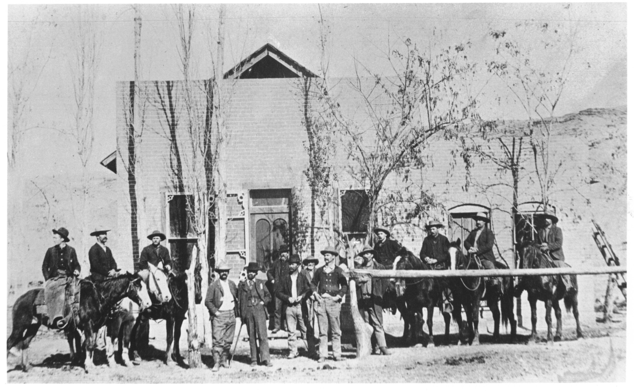 A large group of men are lined up in front of an old building.