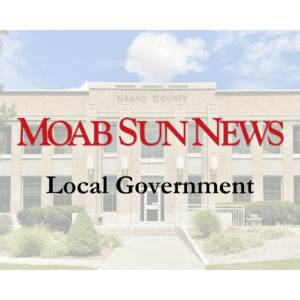 Moab Sun News cover featuring Grand County building, highlighting local government and community news.