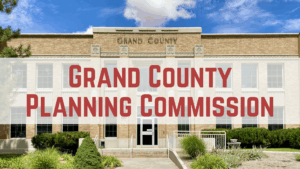 Grand County Planning Commission building exterior with text overlay under a blue sky.