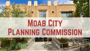 Moab City Planning Commission building entrance with steps and greenery under a clear blue sky.