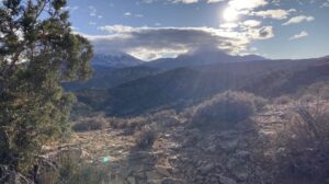 Mountain landscape with sun rays over the Mud Springs Trails outside of Moab.