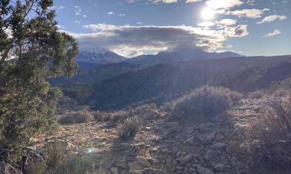 Mountain landscape with sun rays over the Mud Springs Trails outside of Moab.
