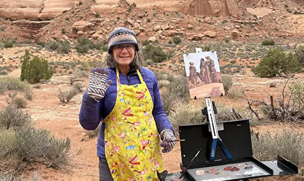 Artist painting outdoors at Arches National Park, capturing stunning rock formations in natural desert landscape.