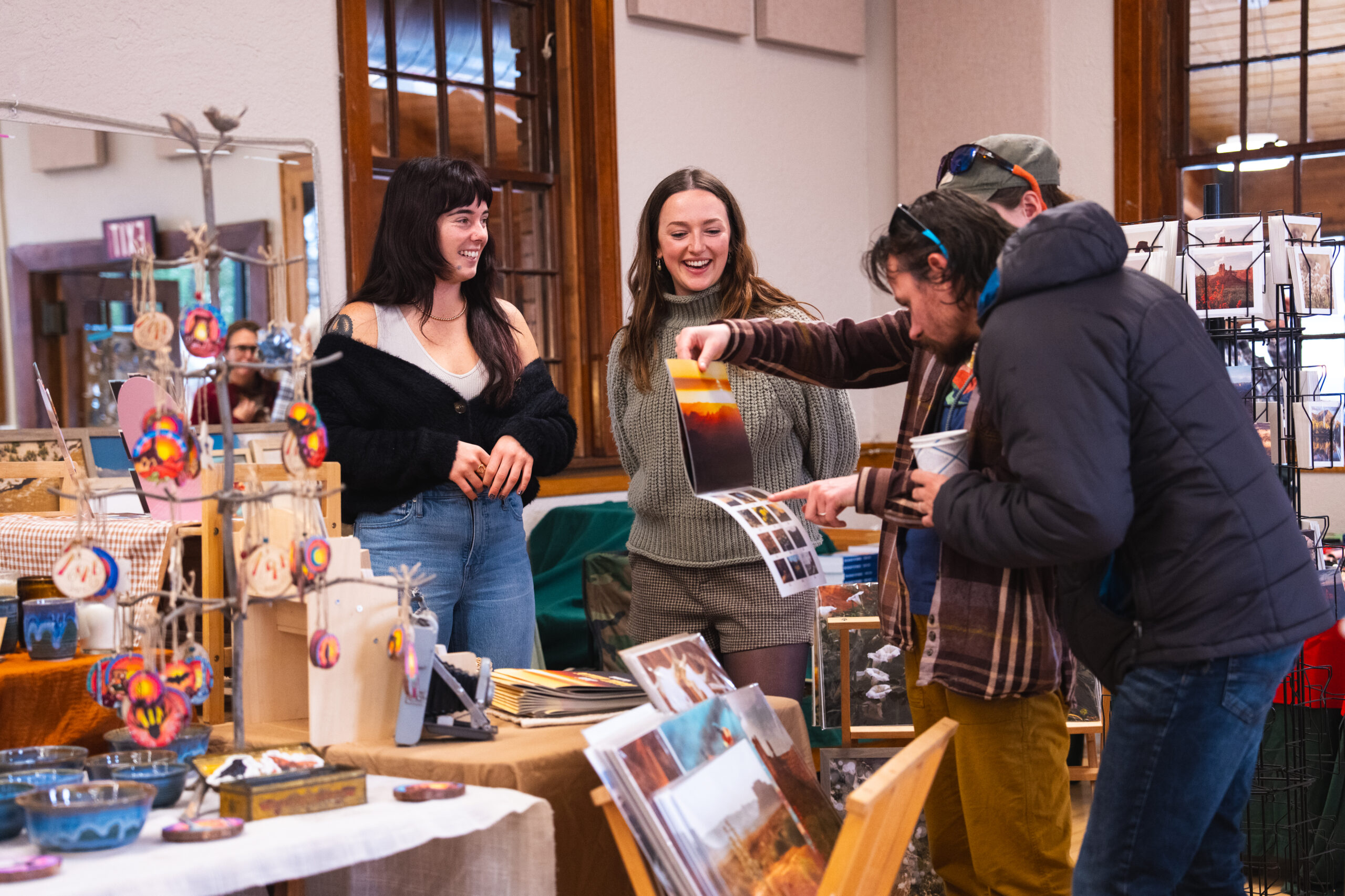 People browsing handmade crafts at a Moab's Holiday Market put on by the Moab Arts Center in 2025.
