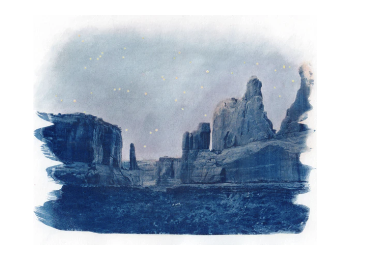 Samantha Jade image Stars twinkle above a serene, rocky desert landscape under a misty night sky.