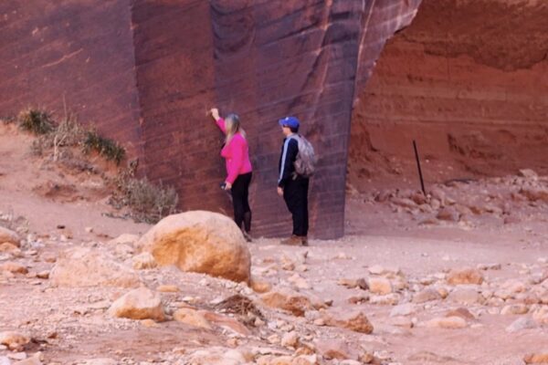 Hikers defacing a rock art panel in Kane County 2024