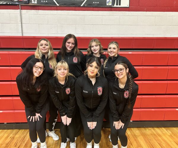 Grand County High School cheer team poses in matching jackets
