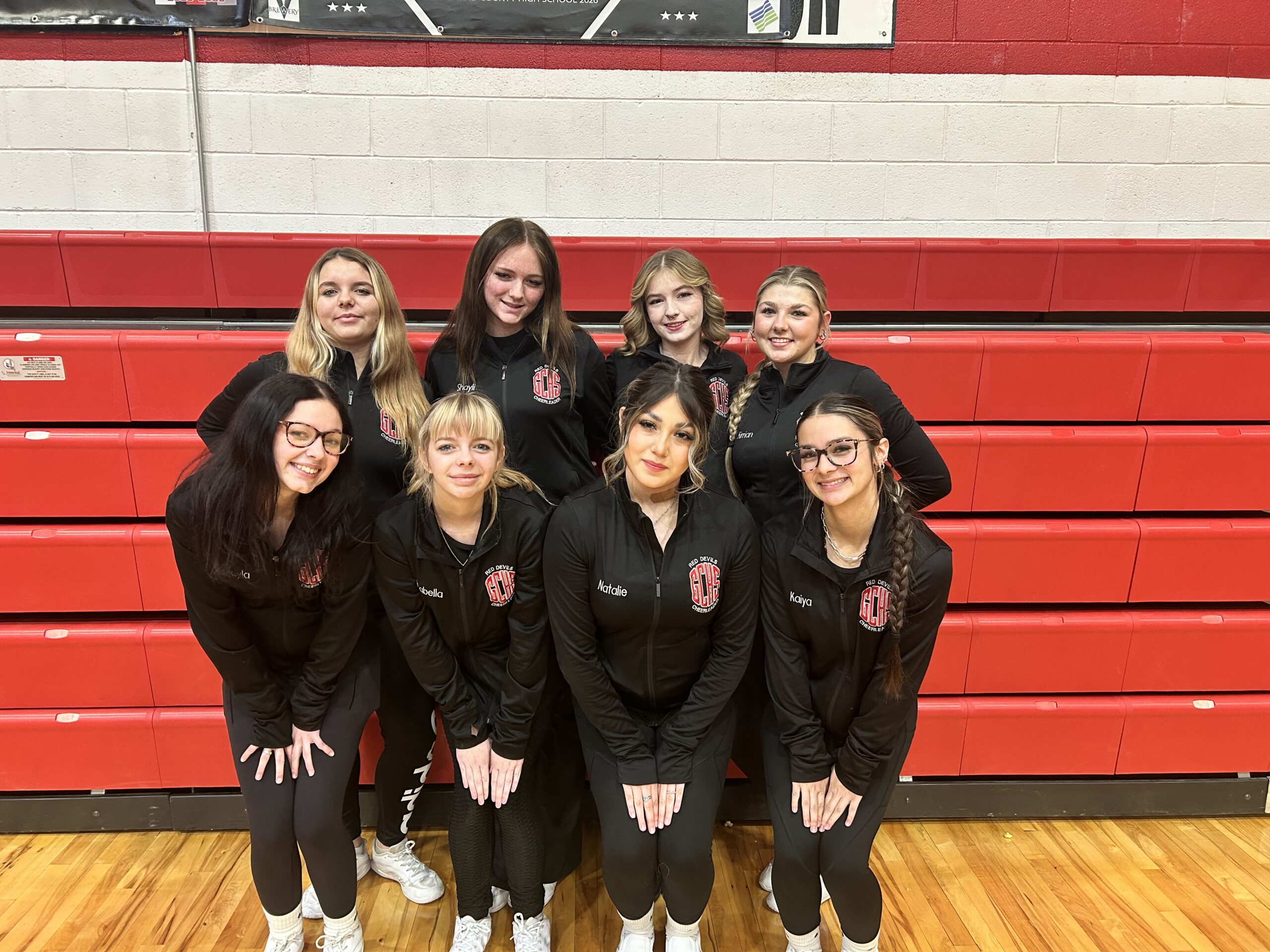 Grand County High School cheer team poses in matching jackets